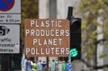 A demonstrator in Westminster with a sign that reads Ã¢â¬ÅPlastic Producers Planet PollutersÃ¢â¬Â